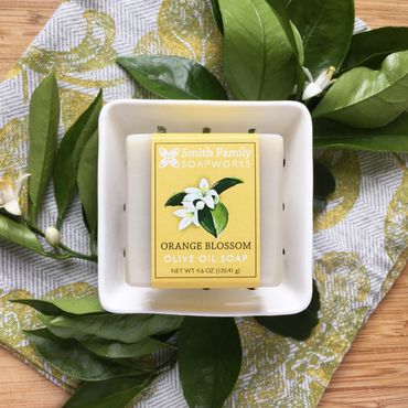 Orange blossom bar soap styled with citrus leaves and blossoms.
