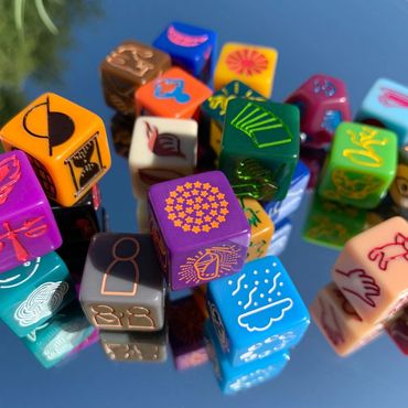 Many different brightly-colored dice, with a unique symbol on each face.