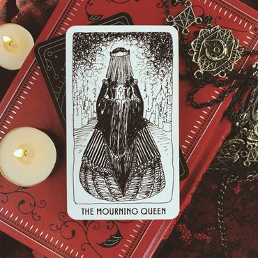 The Mourning Queen: a veiled figure in a black dress holding a lit candle.