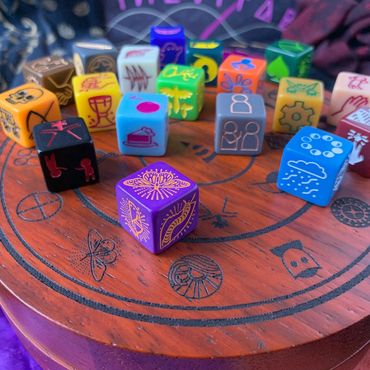 Dice placed on their matching wooden case, which is engraved with the same symbols.
