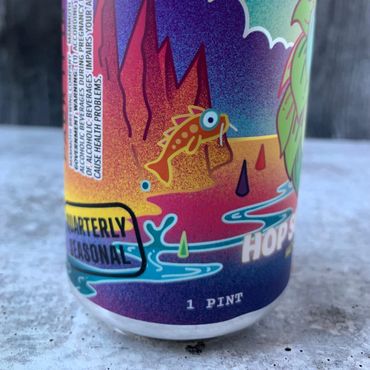 Close-up of Hop Spill showing a stylized fish jumping out of a stream.