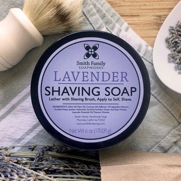Lavender shaving soap with dried lavender, tea towel, and shaving brush.