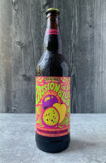 Passion for the Blues bottle with psychedelic lettering, fruit illustration, and fluorescent colors.
