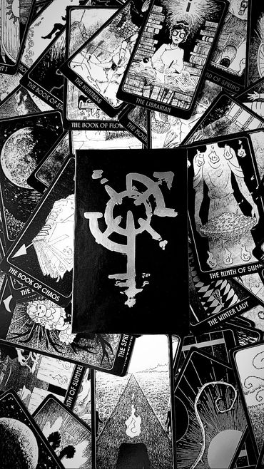 Scattered cards with deck box on top.