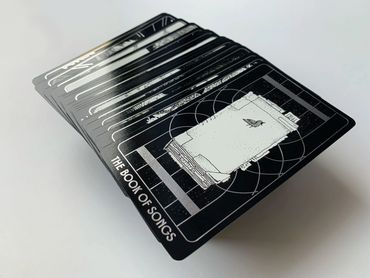 Many of the cards spread out; The Book of Songs is on top.