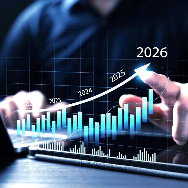 Businessperson pointing at rising digital graph forecasting growth to 2026.