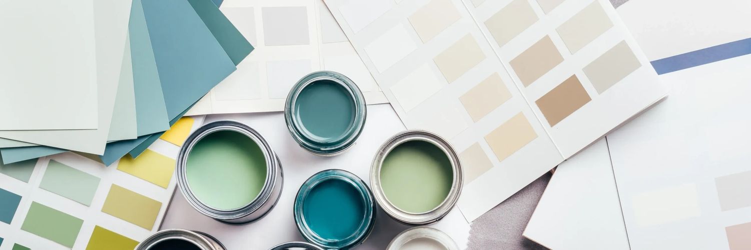 Open paint cans with blue and green shades surrounded by color swatches.