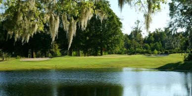 Scenic golf course with pond and trees.