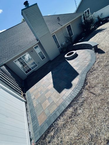 Piano patio with moon slice seating wall along with the always necessary smores cooking station