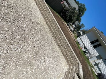 parking area inset into hillside from alleyway for extra parking