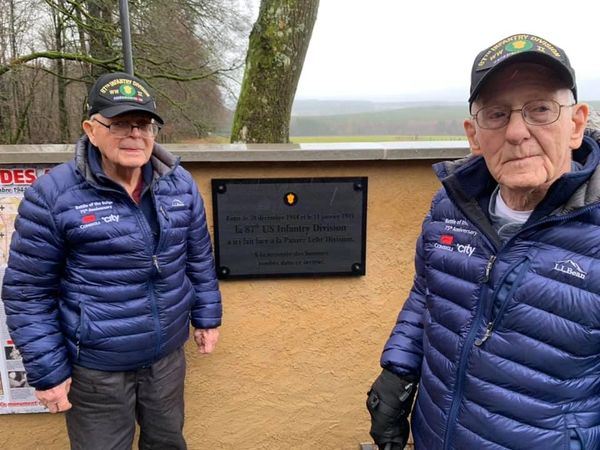 87th Division veterans Rodney Perkins and Ernie Roberts pose with their unit's monument