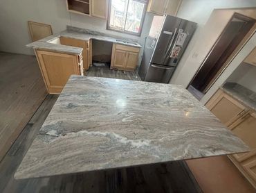Newly installed marble kitchen countertops in a modern kitchen setup.
