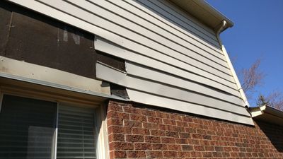 Residential home showing areas of siding that needs repair or replacement.