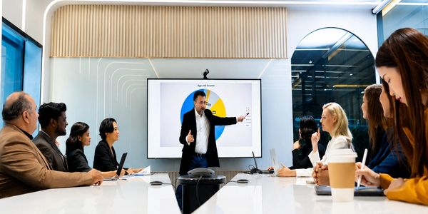 Business meeting with a presenter explaining a chart.
