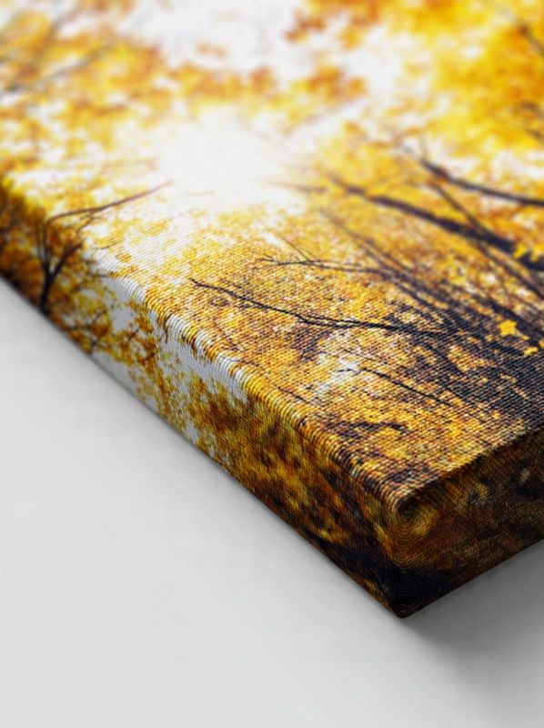 Close-up of canvas art depicting autumn trees with golden leaves.