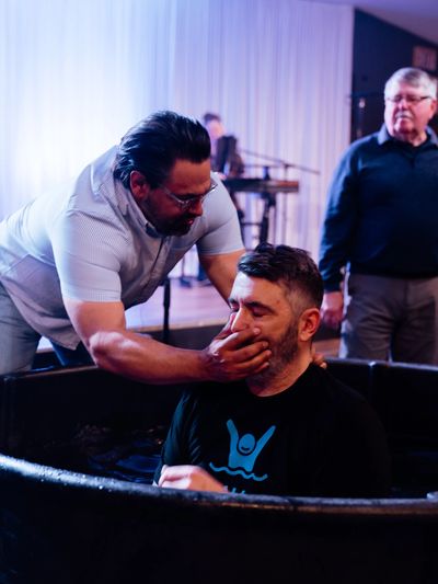 Pastor Nathan Hurst baptising a new believer at Grace Family Church in Davenport