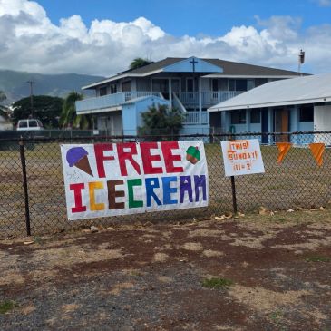 Sign offering free ice cream on a fence.