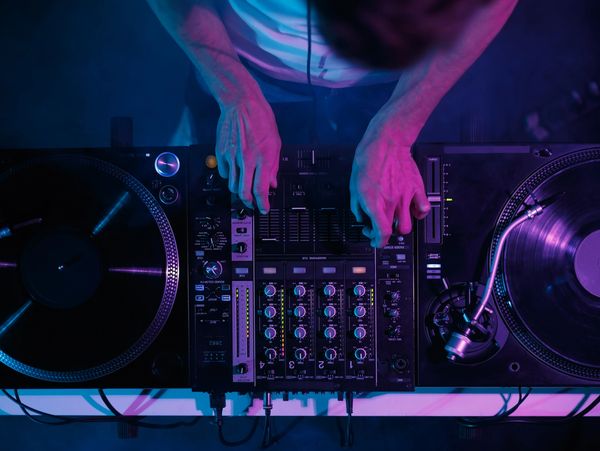 Hip hop dj plays music on concert.