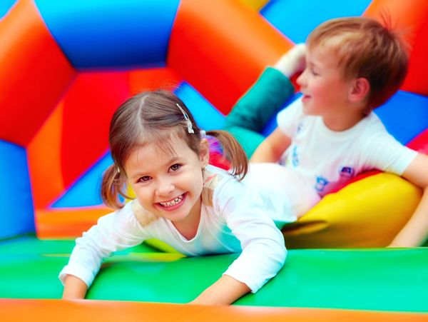 Happy kids having fun on playground in kindergarten