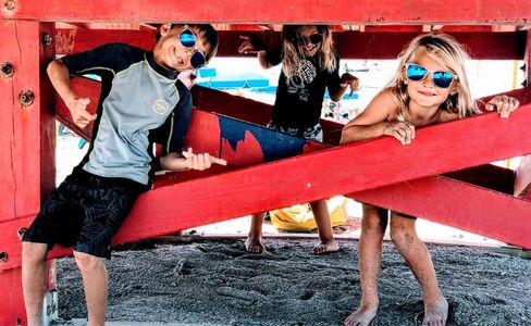 Kids having fun on the beach. Surf School and Surf Lessons