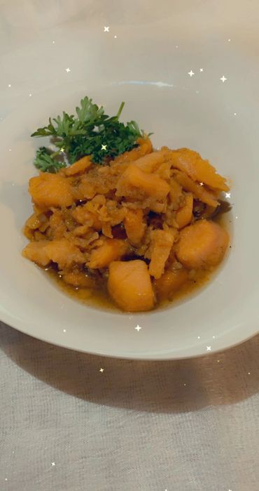 white bowl with yams and sauce with garnish