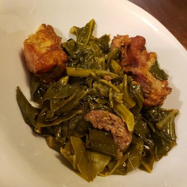meat with greens on a white plate