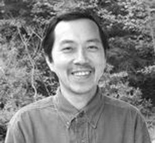 Black and white image of a man with long black hairs