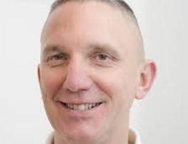 Front angle view of a man smiling at the camera