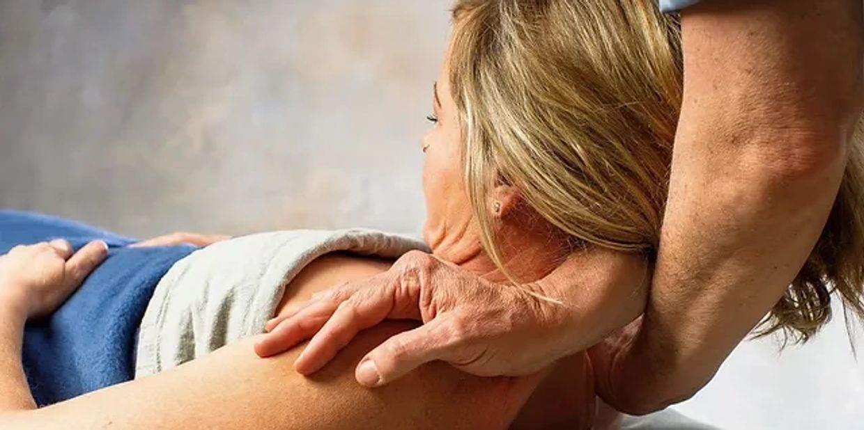 A man holding the back of a girl lying on the bed