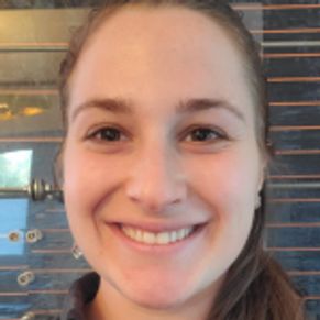 Front angle view of a small girl smiling at the camera