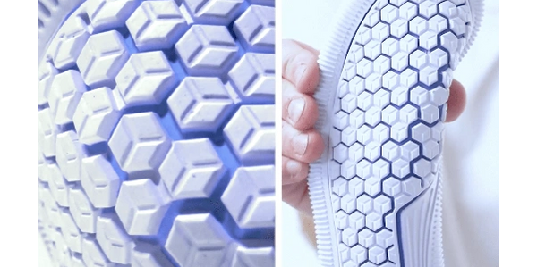 An outsole being squeezed to show it's flexibility and tread