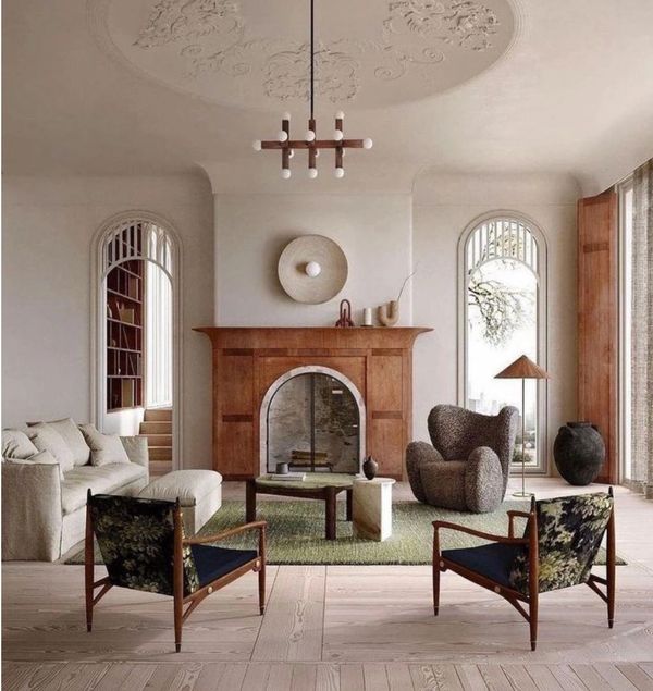 Elegant living room with wooden fireplace and stylish furniture.