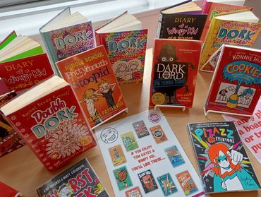 A collection of popular children's books, including Dork Diaries and Diary of a Wimpy Kid.