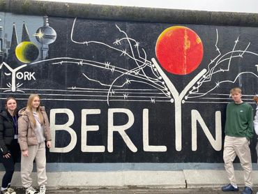 Students by the Berlin Wall "BerlYn" mural
