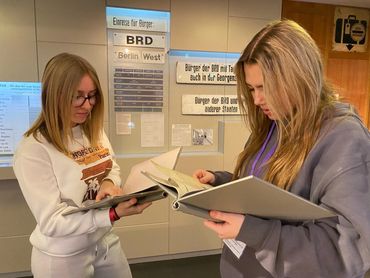 2 people reading binders