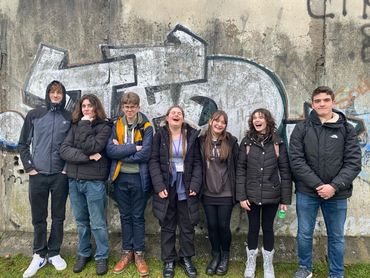 Students posing in front of a graffitied section of the Berlin Wall (1 of 2)