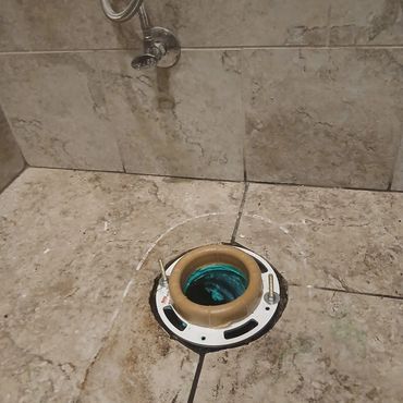 A failing toilet seal causing leaks around the base, leading to instability and potential floor dama