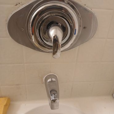 A brand-new shower handle professionally installed, sealing the wall opening and restoring smooth, r