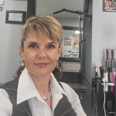 Woman smiling inside a salon.