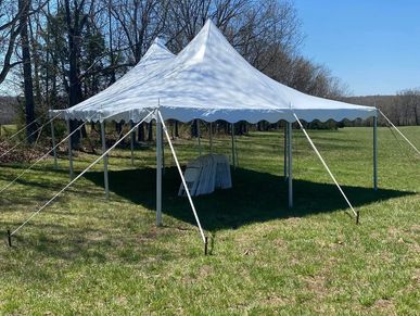 White event tent on a grassy field.
