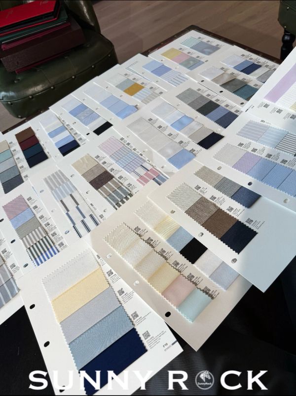Fabric swatches arranged on a table for selection.