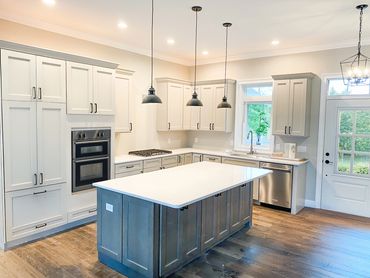 Modern kitchen with white cabinets and a large island.