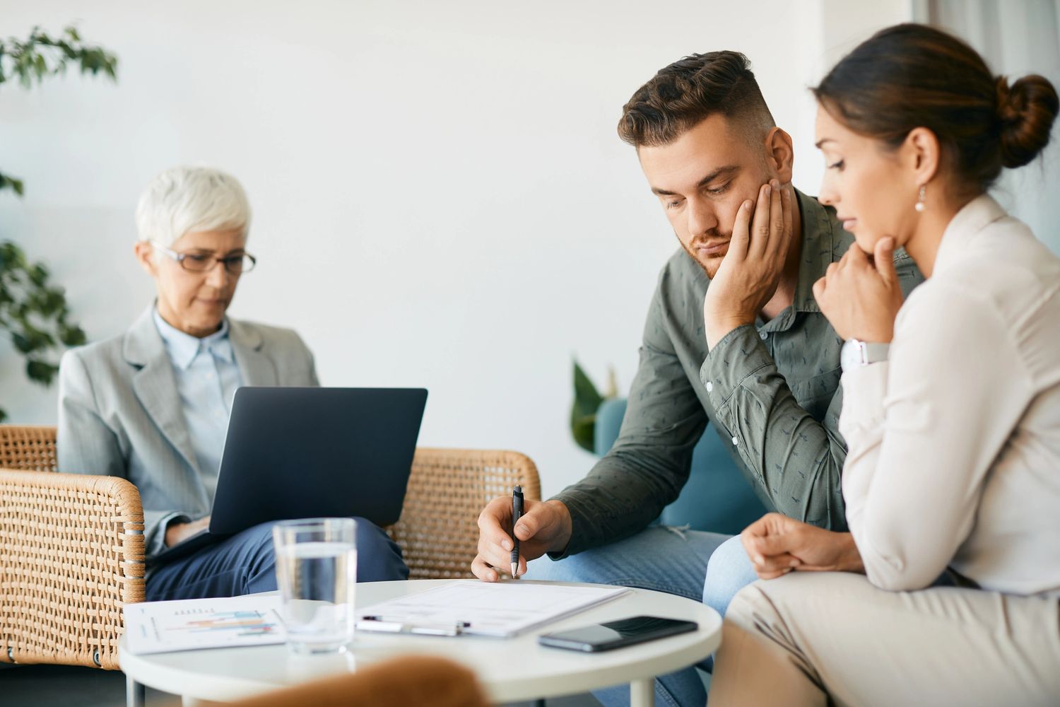 Stack of books next to pencils in a holder and a camera.