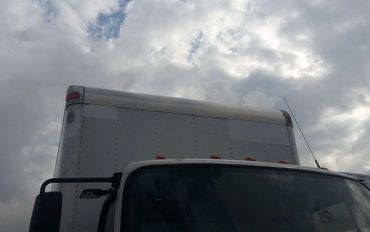 The Front Projection of a Container Truck in White