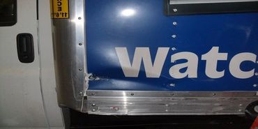 A Logo in the Side of a Truck in Blue and White