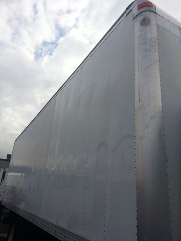 A Corner Section of a Container Truck in White