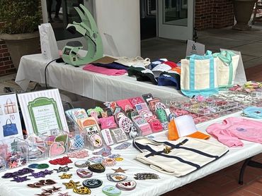 Our table displaying patches, bags, and apparel for events and fundraisers.