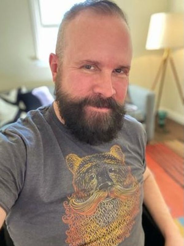Bearded man wearing a t-shirt with a bear design.