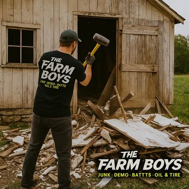 a man wielding a sledgehammer doing barn demolition