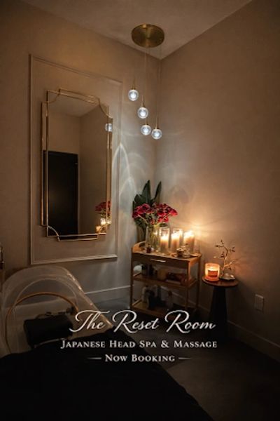 Cozy spa room with candles, flowers, and soft lighting.